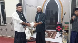 Anggota Tim VII Masruru Salele Menyerahkan Wakaf Al-Qur'an kepada Sekretaris Mushollah Cokro Aminoto Petta Balane